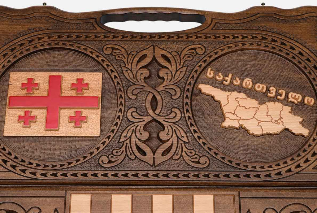 Angled view of the handmade Georgian backgammon set showing both carvings
