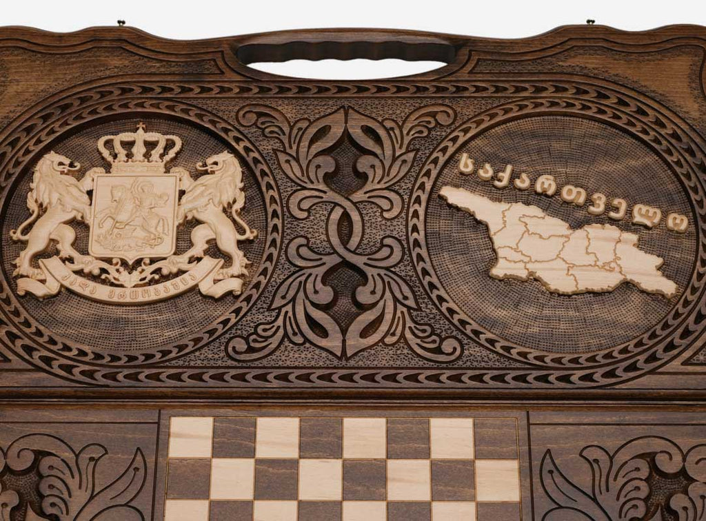 Angled view of the handmade Georgian backgammon set showing both carvings on the lid