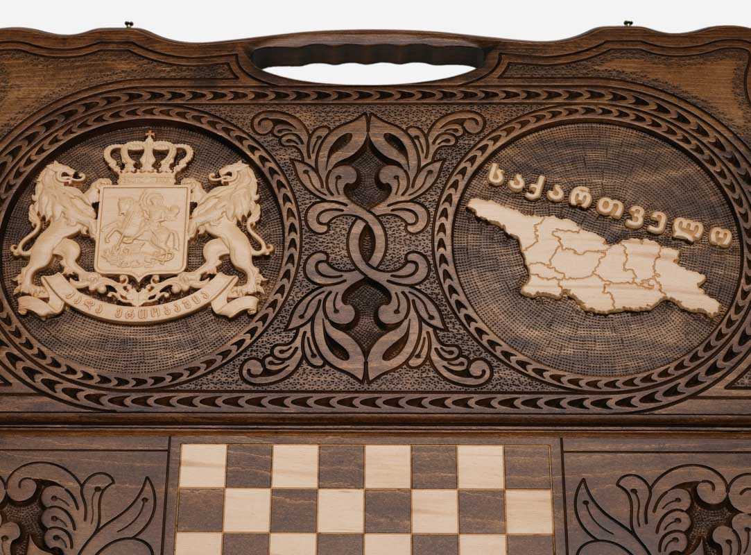 Angled view of the handmade Georgian backgammon set showing both carvings on the lid