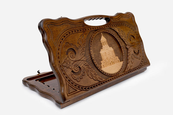 Carved Georgian backgammon board with the Holy Trinity Cathedral of Tbilisi and a cut-out carry handle, propped open