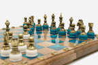 Overhead view of the turquoise epoxy board and the full set of 32 bronze pieces