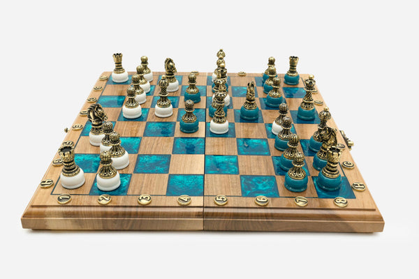 Luxury walnut chess set with marbled turquoise epoxy squares and ornate bronze pieces on white bases, set up for play