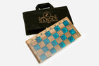 Angled view of the complete turquoise epoxy chess set with brass coordinate markers