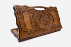 Carved Armenian backgammon board with a deep central ornament, interlaced panels and a cut-out carry handle, propped open