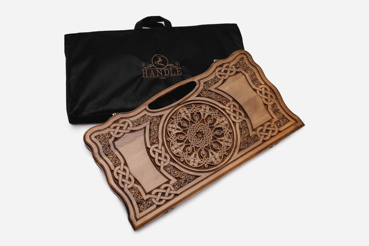 The cut-out carry handle and the upper carving of the lid