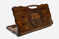 Hand-carved wooden backgammon board with an elephant and a cut-out carry handle, propped open