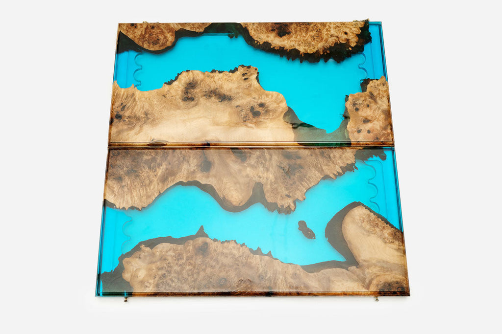 Detail of the glossy turquoise epoxy surface and natural walnut grain