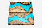 Detail of the glossy turquoise epoxy surface and natural walnut grain