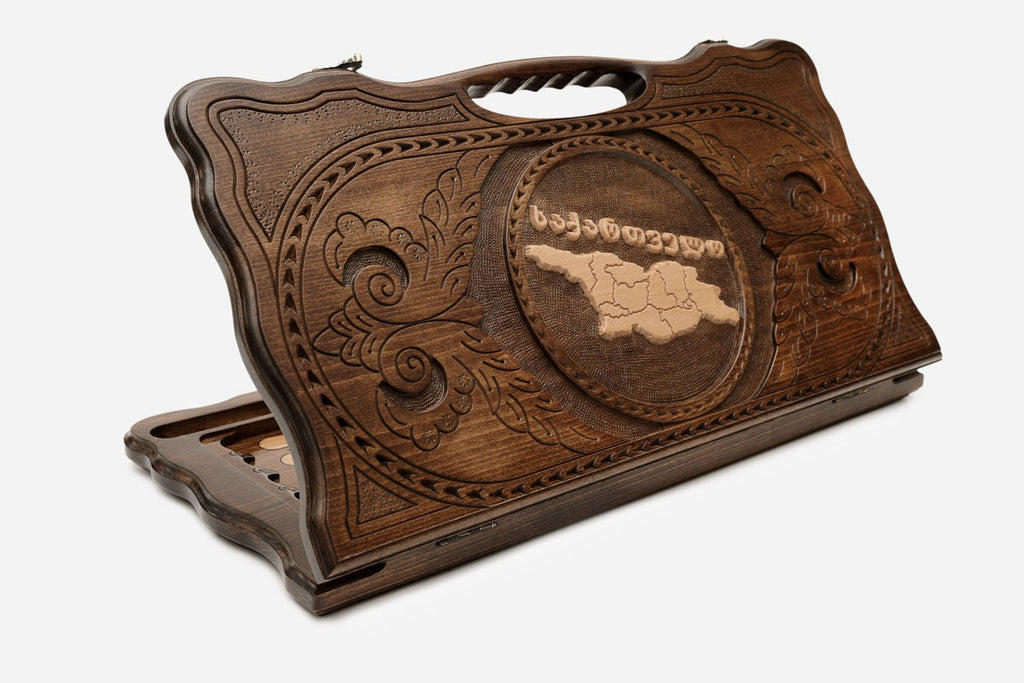 Carved Georgian backgammon board with the map of Georgia and a cut-out carry handle, propped open