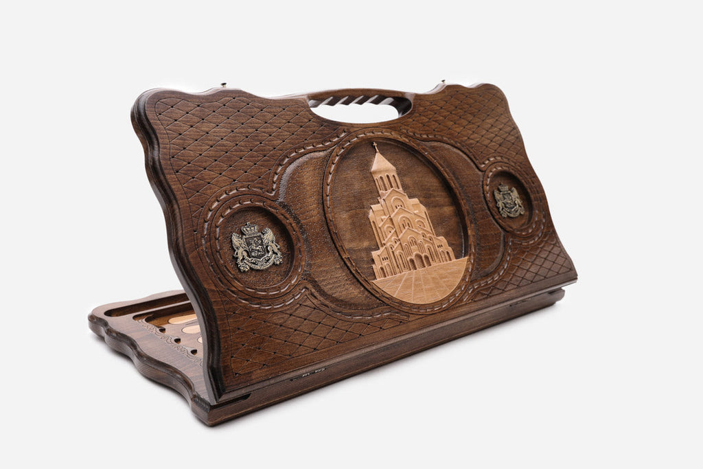 Carved Georgian backgammon board with the Sameba Cathedral, bronze roundels and a cut-out carry handle, propped open