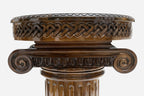 Detail of the hand-carved column capital supporting the round table top
