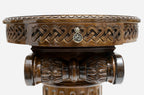 Close-up of the woven interlace apron and brass pendant above the fluted column