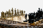 Close-up of the Crusader chess pieces, a gilded brass army facing a black army of medieval knights, kings and castle rooks