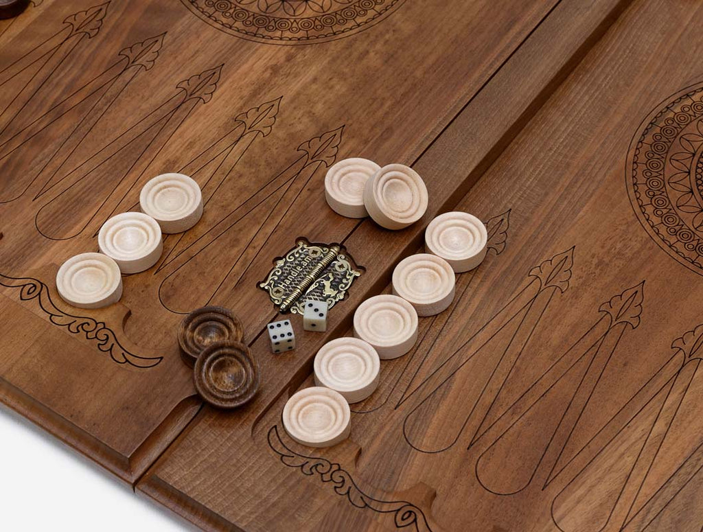 Close-up of the deep walnut carving and the shadow it throws