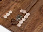 Close-up of the deep walnut carving and the shadow it throws
