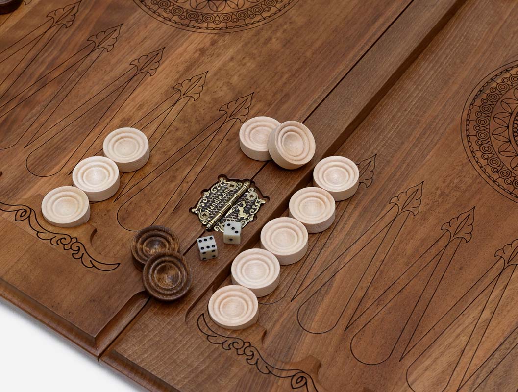 Close-up of the deep walnut carving and the shadow it throws
