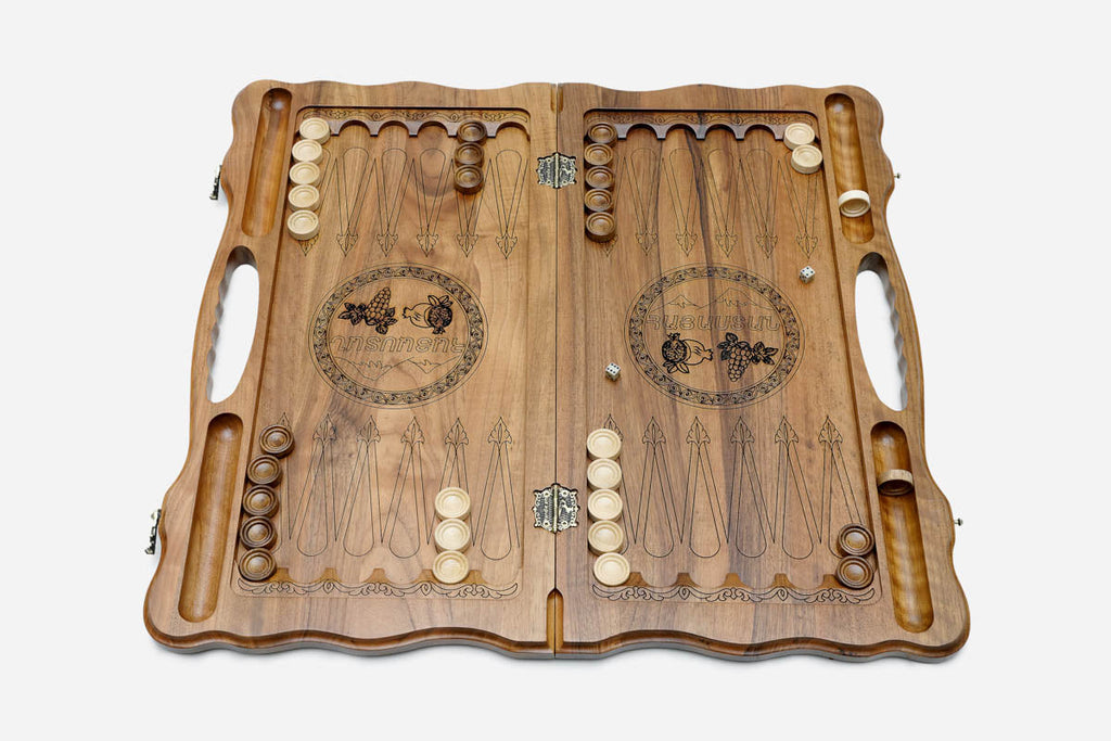 Side view of the folded walnut board showing its bronze hinges