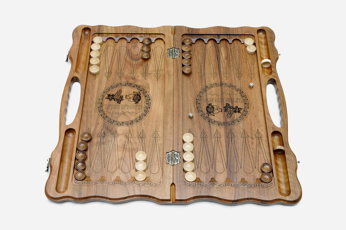 Side view of the folded walnut board showing its bronze hinges