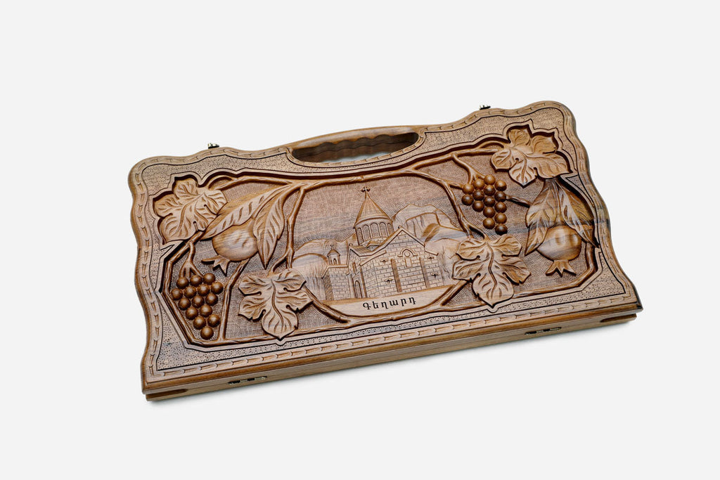 Angled view of the luxury walnut backgammon set showing the carved lid