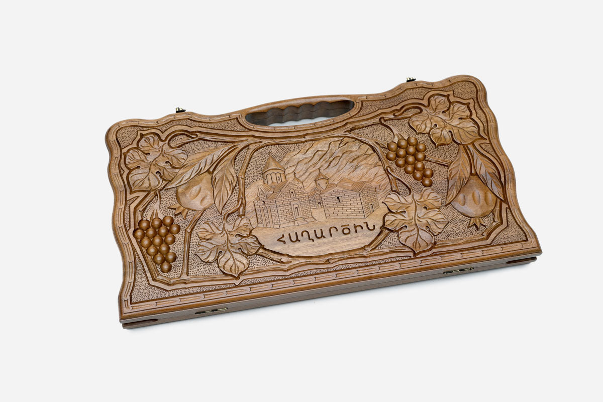 Angled view of the luxury walnut backgammon set showing the carved lid