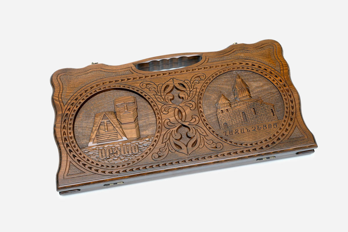 Angled view of the handmade Armenian backgammon set showing both carvings
