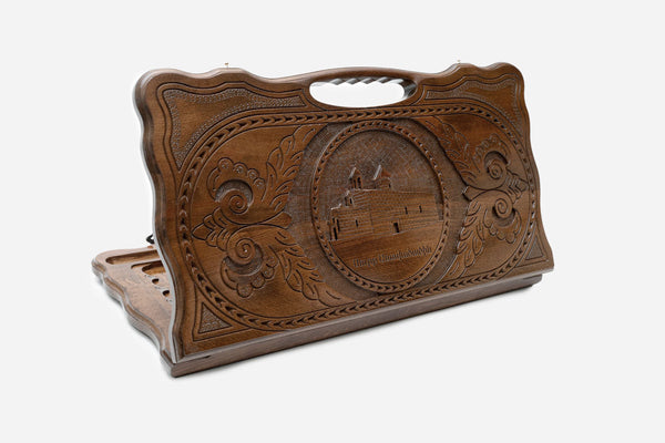 Carved Armenian backgammon board with St. Mary Church and a cut-out carry handle, propped open