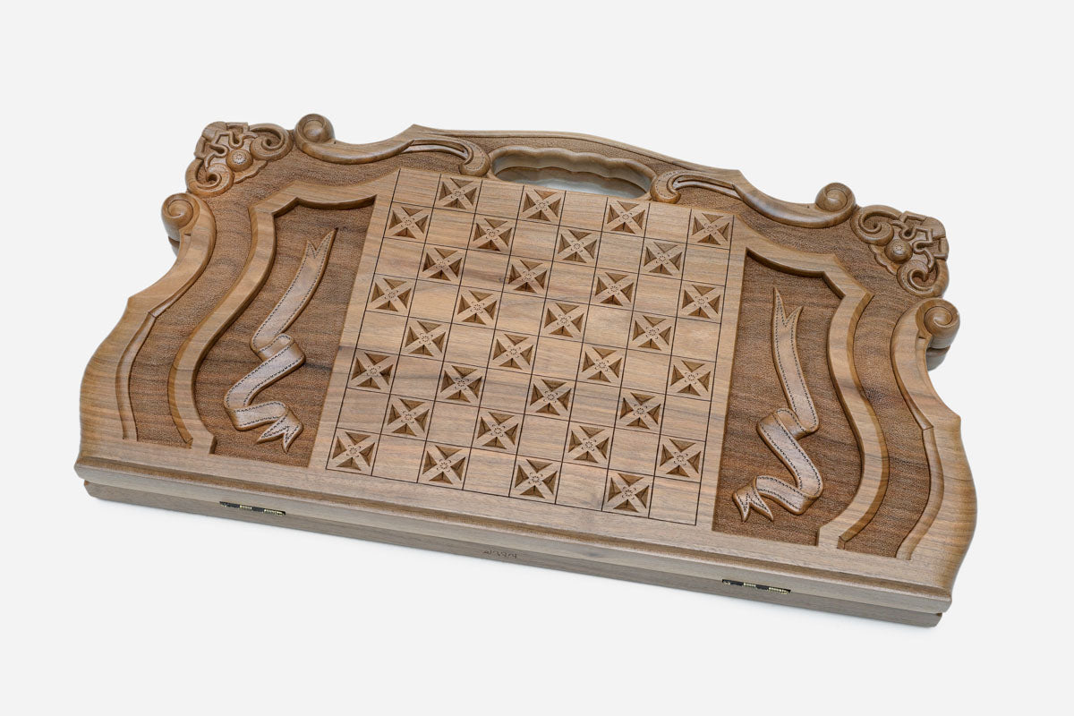 Close-up of the lion's face carved in deep relief into walnut