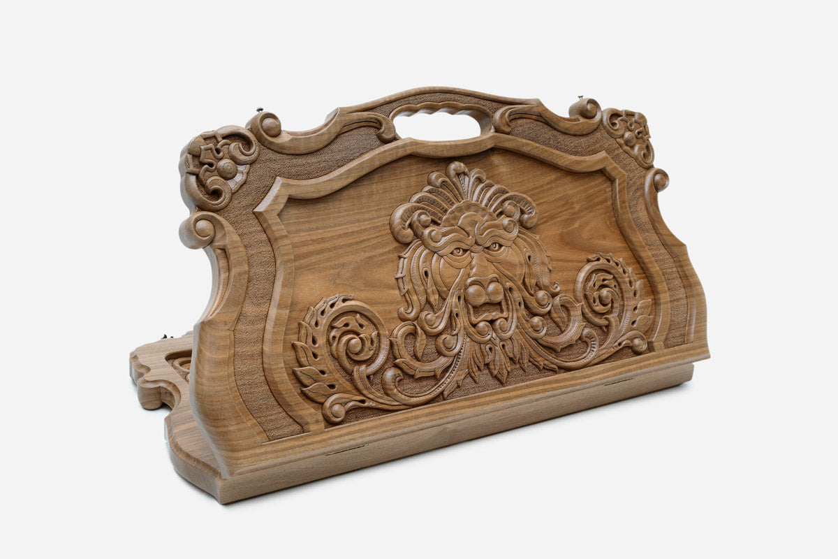 Master-carved walnut Armenian backgammon board with a lion in an ornate cartouche and a cut-out carry handle, propped open