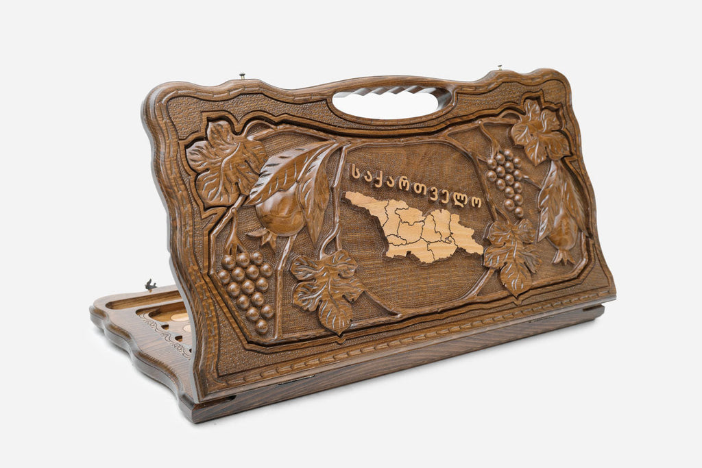 Carved Georgian backgammon board with the map of Georgia in a border of vines and blossom, cut-out carry handle, propped open