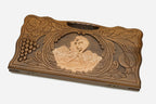Angled view of the handmade backgammon set showing the carved scene