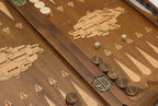 Side view of the folded board showing its bronze hinges and clasps
