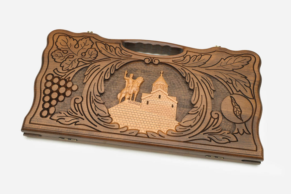 Angled view of the handmade Georgian backgammon set showing the carved lid