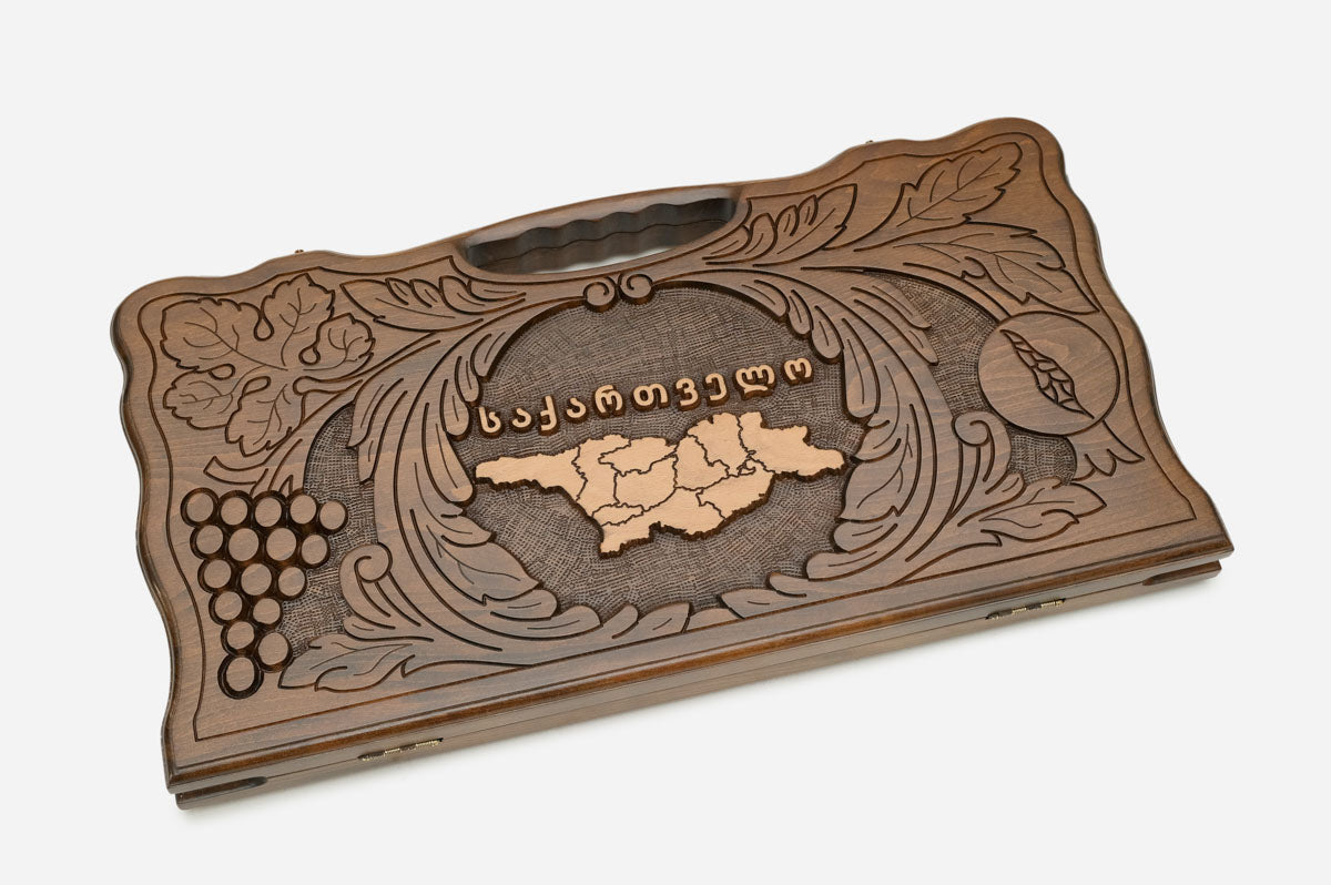 Angled view of the handmade Georgian backgammon set showing the carved lid
