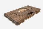 The cut-out carry handle and the upper carving of the lid