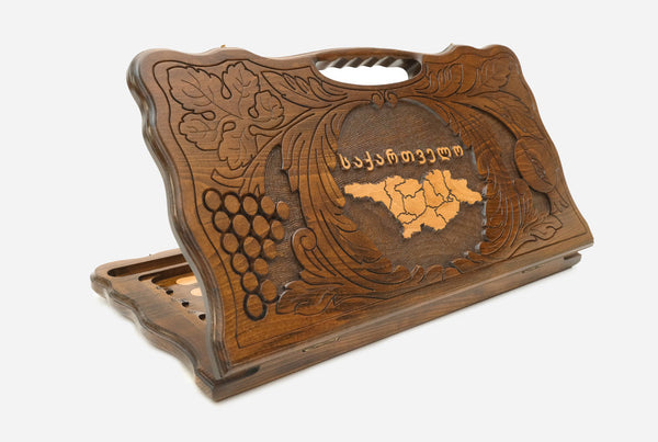 Carved Georgian backgammon board with the map of Georgia in a wreath of grapevines, cut-out carry handle, propped open