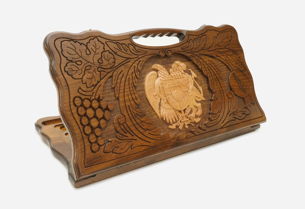Carved Armenian backgammon board with the coat of arms in a wreath of grapevines, cut-out carry handle, propped open