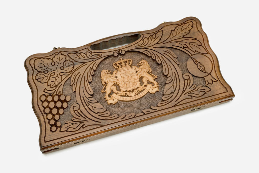 Carved Georgian backgammon board with the coat of arms and guardian lions, cut-out carry handle, propped open