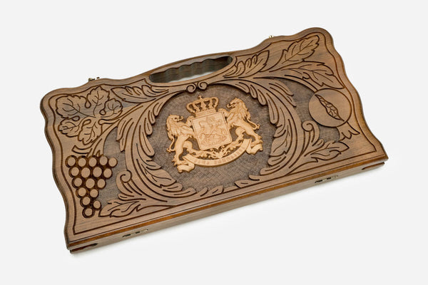 Carved Georgian backgammon board with the coat of arms and guardian lions, cut-out carry handle, propped open
