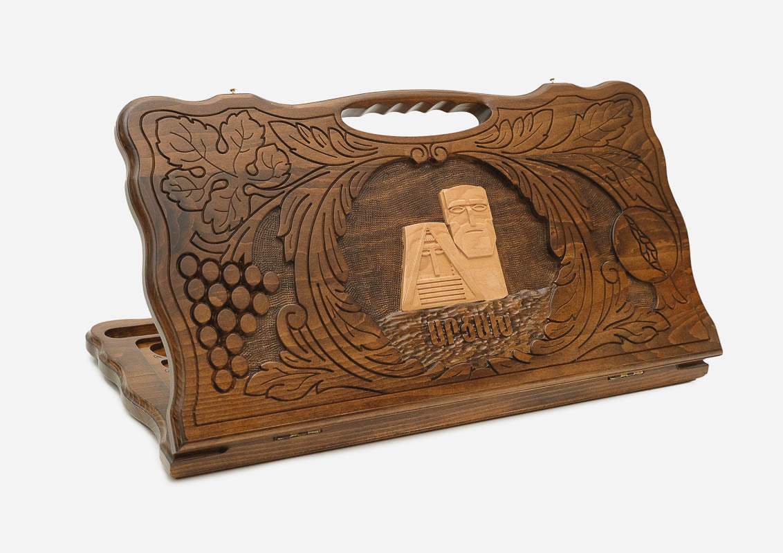 Carved Armenian backgammon board with the We Are Our Mountains monument in a border of grapevines, cut-out carry handle, propped open