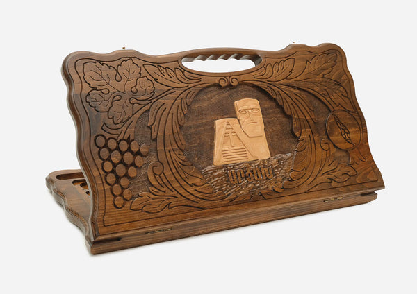 Carved Armenian backgammon board with the We Are Our Mountains monument in a border of grapevines, cut-out carry handle, propped open