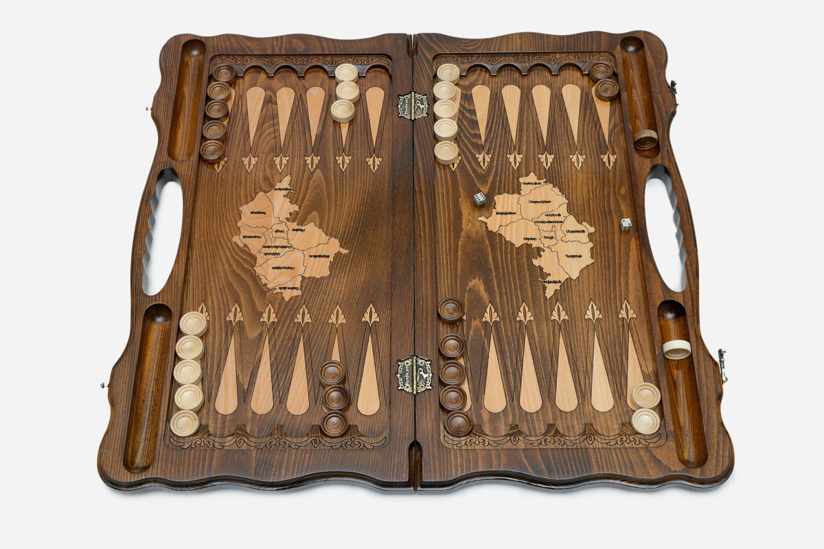 Side view of the folded board showing its bronze hinges and clasps