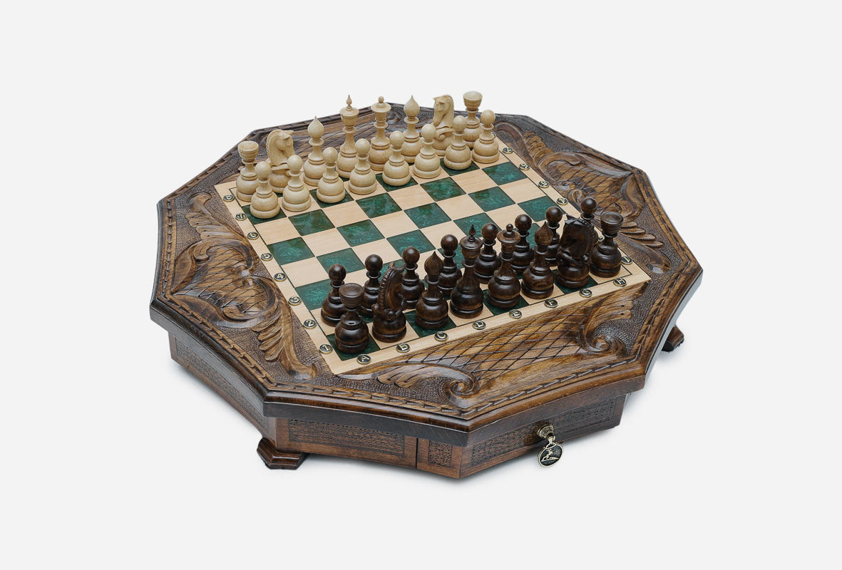 The full octagonal green epoxy chess board with light and dark pieces in starting position