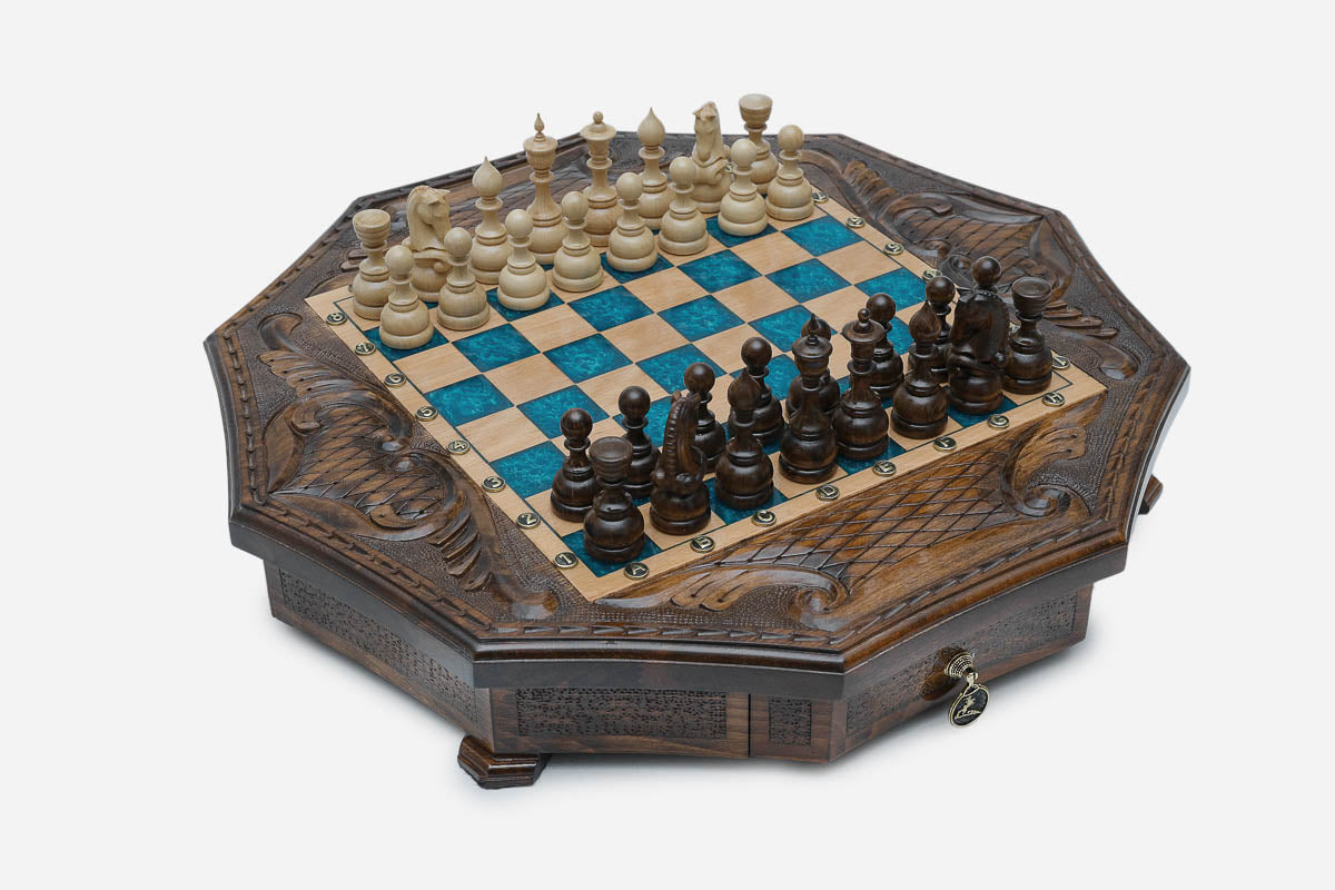 Angled view of the blue epoxy board framed by its carved eagle corner reliefs