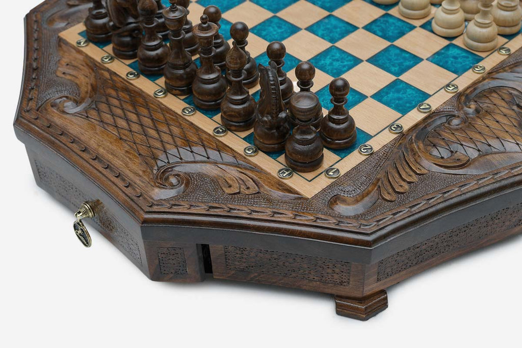 Close-up of the dark wooden chess pieces standing on the blue epoxy board