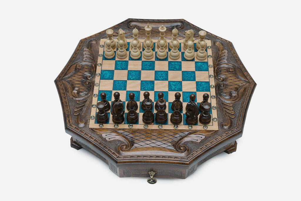 The full octagonal blue epoxy chess board with light and dark pieces in starting position