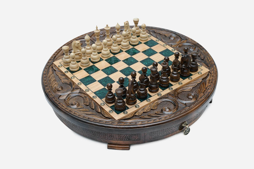 Angled view of the green epoxy chess board with light and dark pieces in starting position