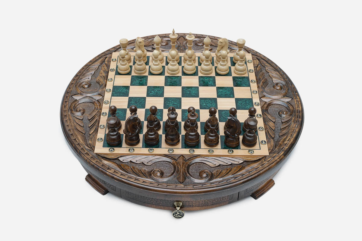 Round chess set with storage, emerald-green epoxy squares and turned wooden pieces arranged for play