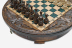 Detail of the carved scrollwork frame running around the round playing surface