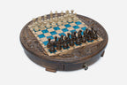 Full view of the round blue epoxy chess board with light and dark pieces in starting position