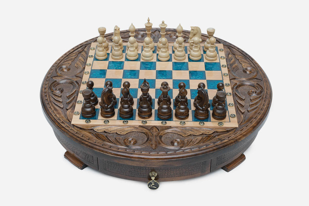 Round chess set with storage, turquoise-blue epoxy squares and turned wooden pieces set up for play